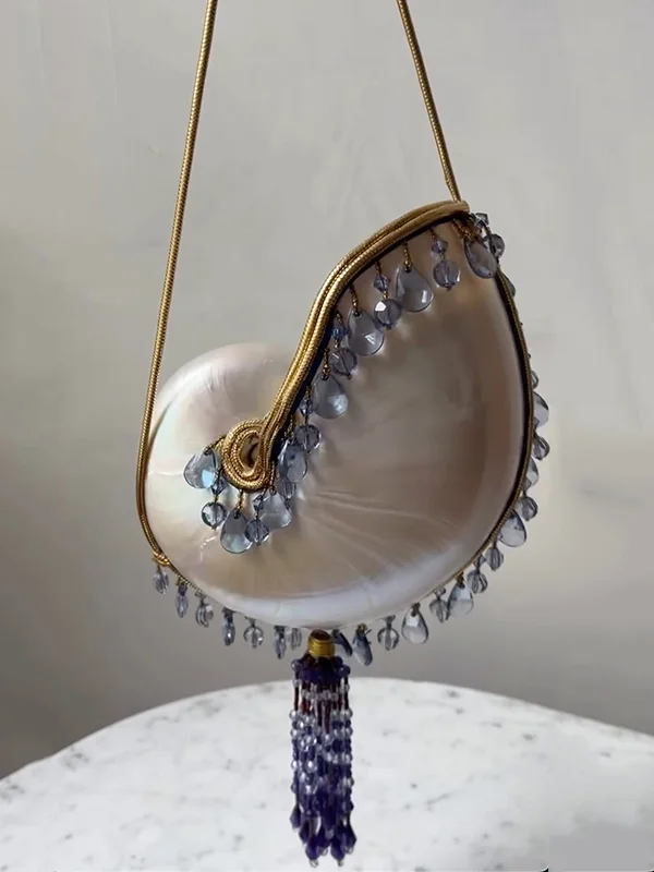 pearlized shell bag with glass adorned pendants and tassel