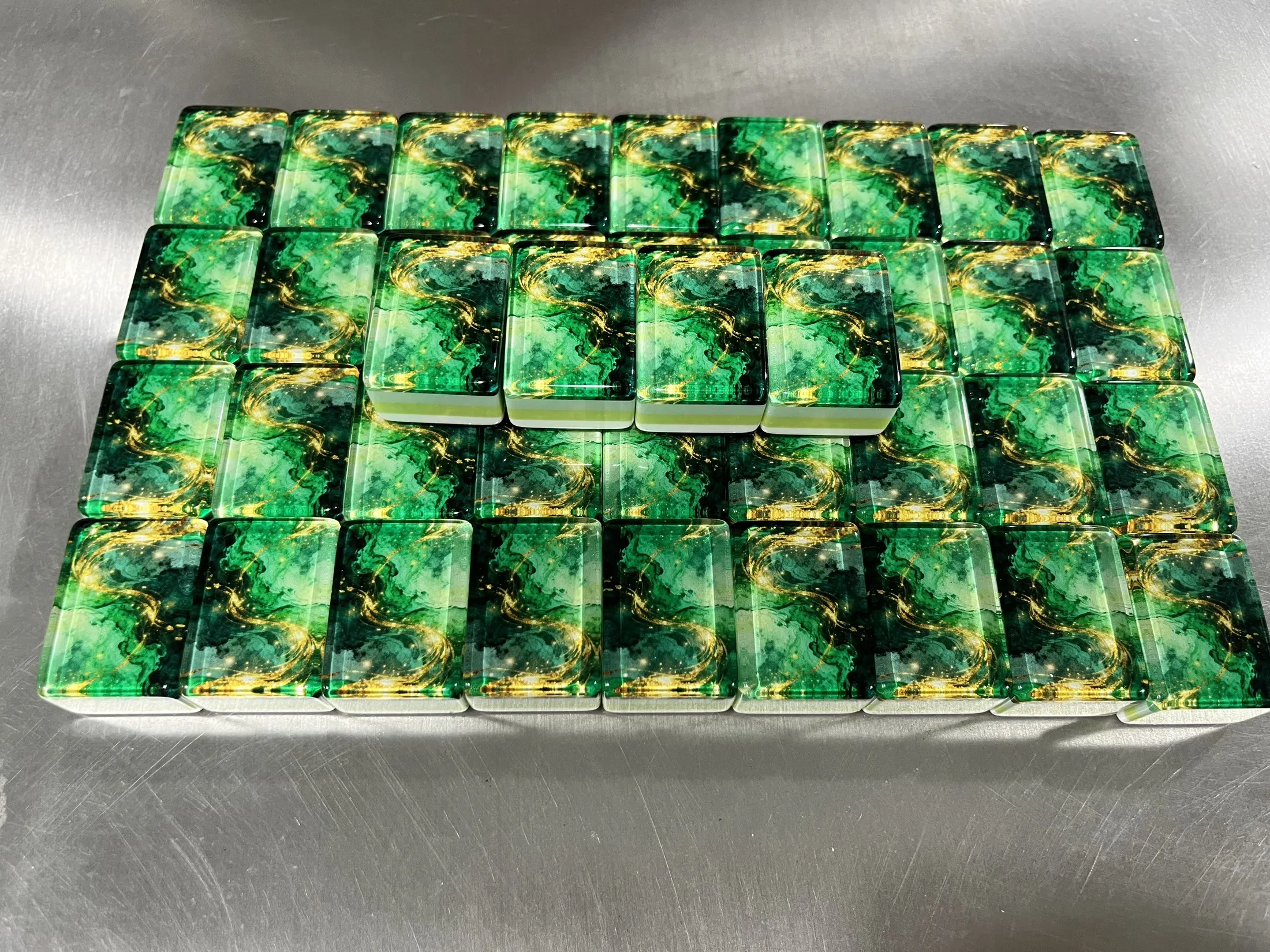 Authentic Emerald Gold tiles arranged to show backs and layered sides.
