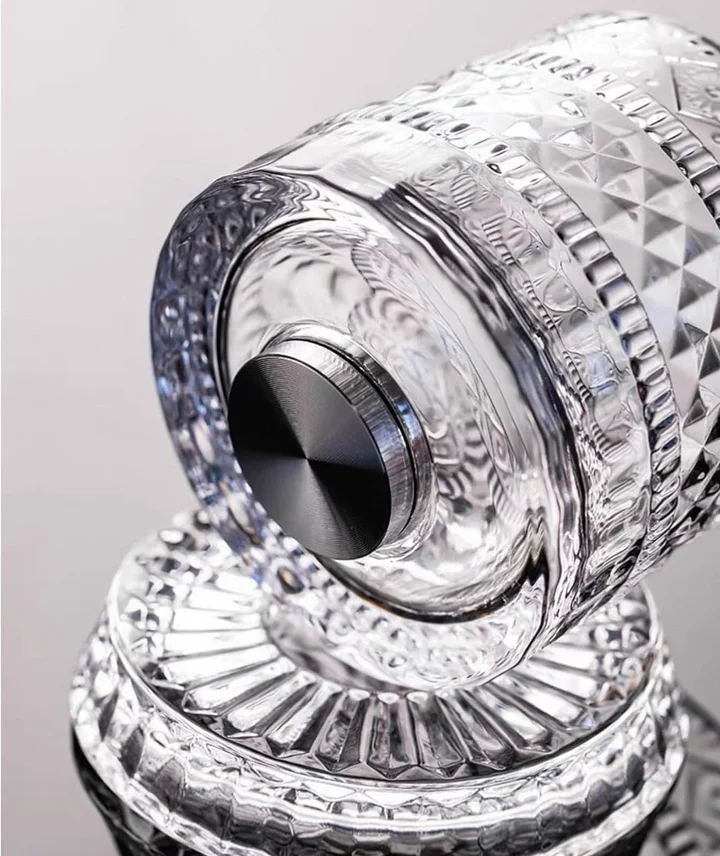 Close-up of the glass's base showing the spinning mechanism and crystal cutting