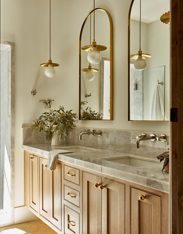 brushed brass light used over marble vanity
