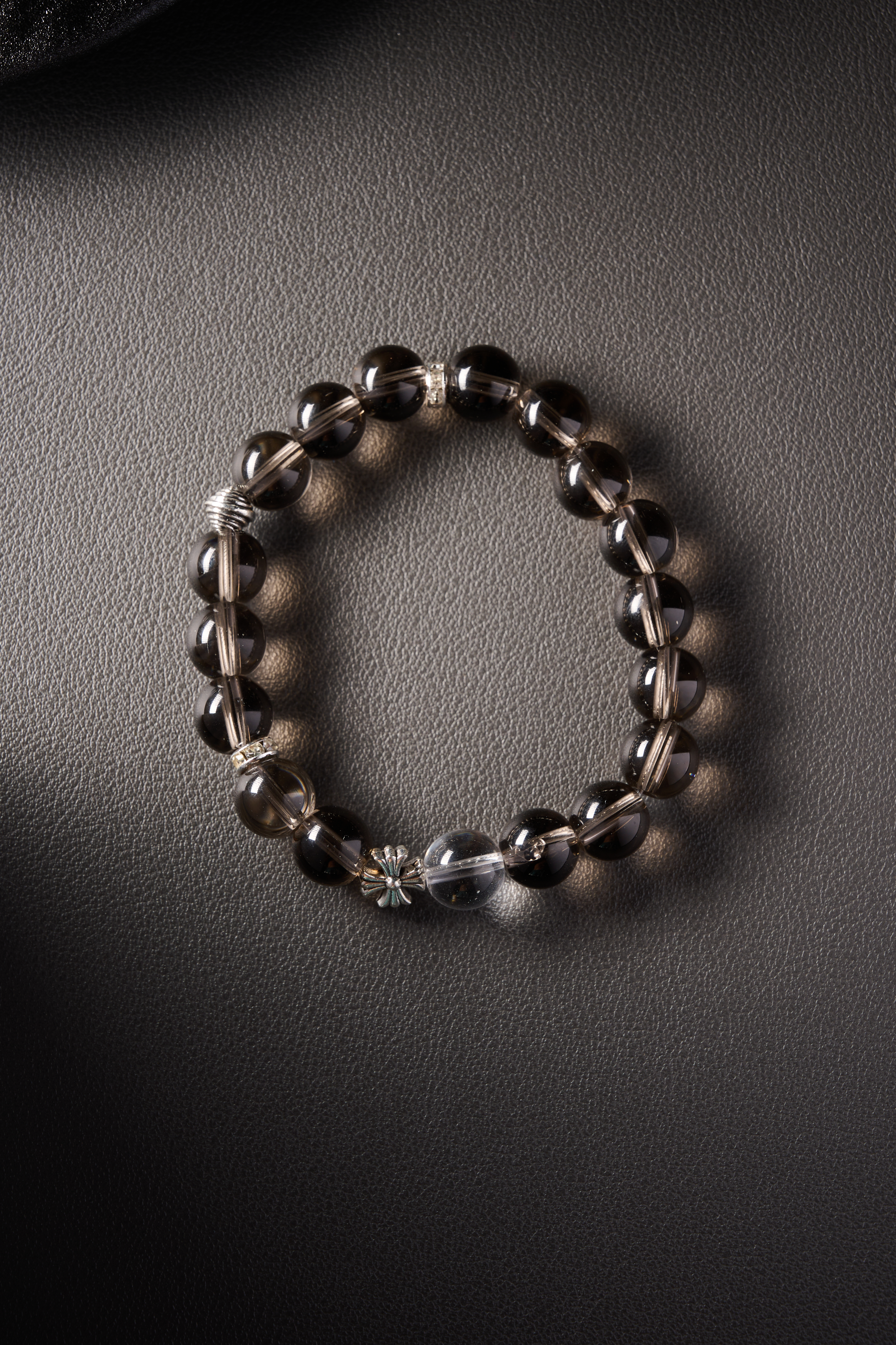 Hero image – natural smoky quartz beaded bracelet on dark background, polished round beads with subtle brown translucency.