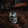 Bearded tough guy wearing hat skull rings for men
