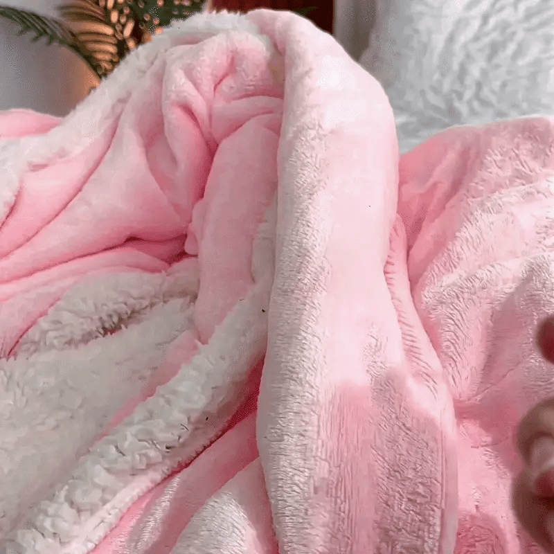 Animated close-up of the pink wearable blanket's plush fleece texture