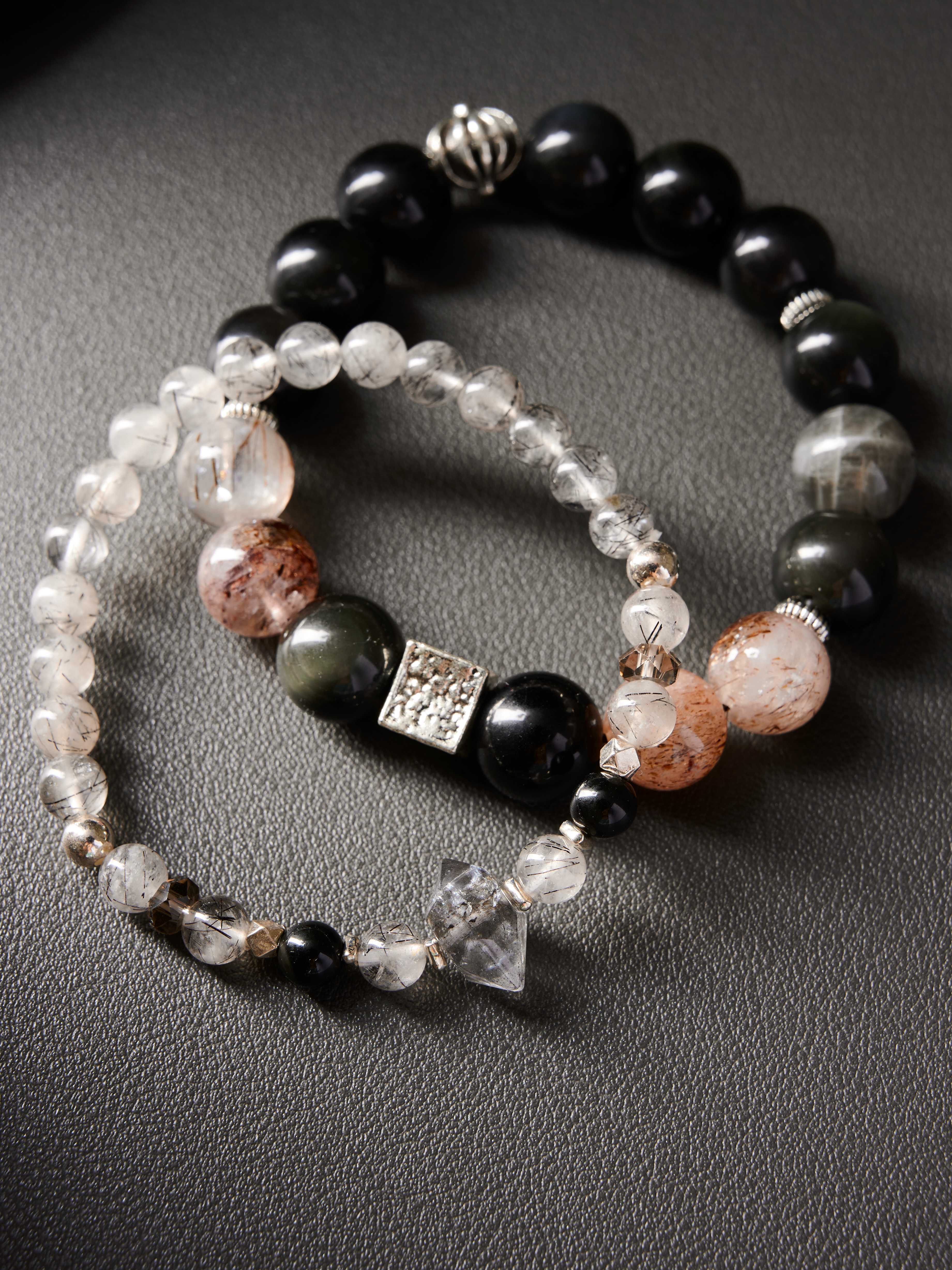 Couple set arranged in circle on neutral background, smoky quartz and clear quartz accents, hand-strung