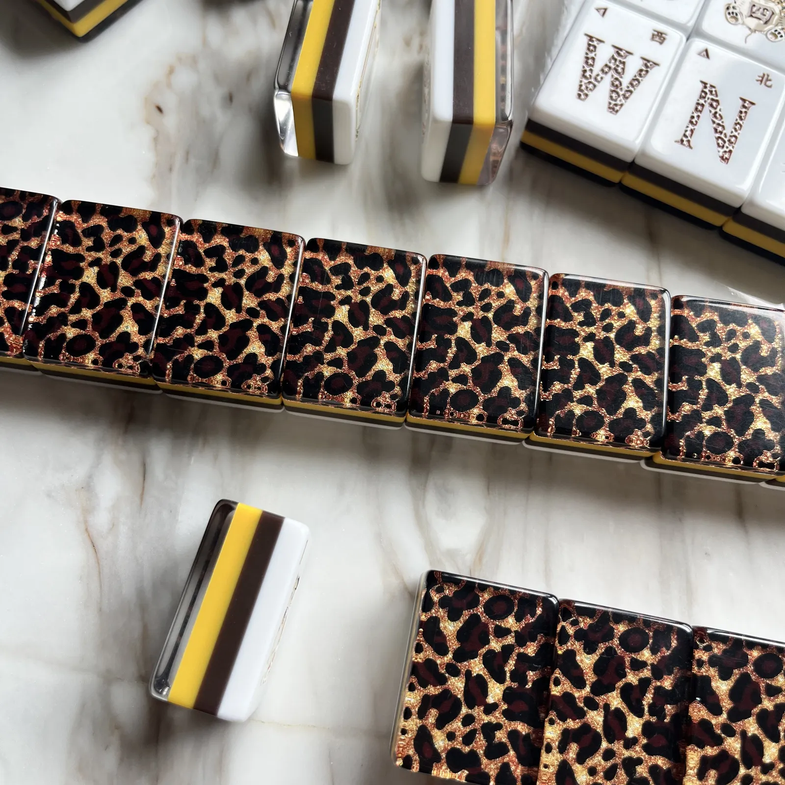 Close view of the opaque leopard-print back and white, chocolate-brown, and golden-yellow four-layer construction.