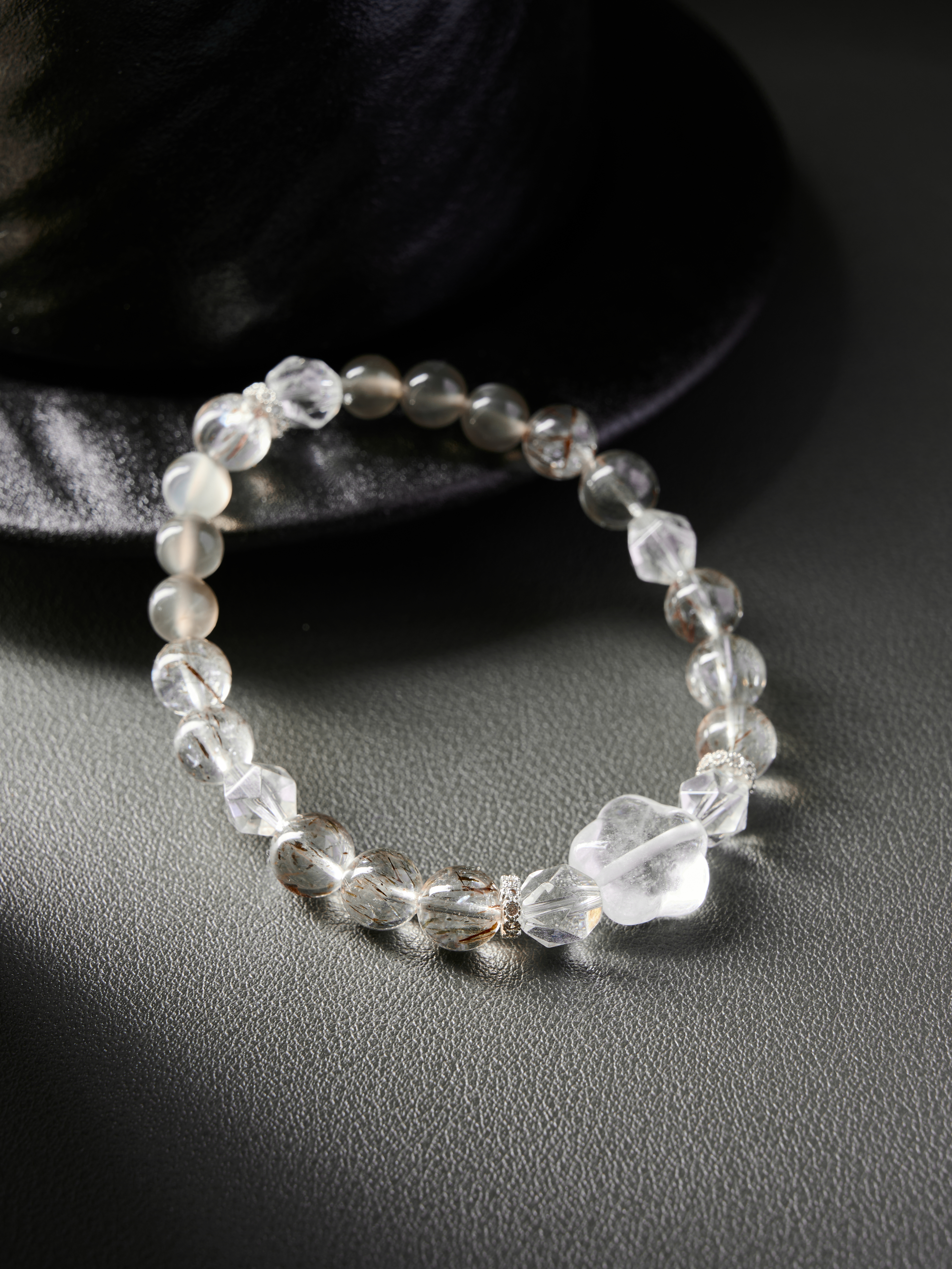 Low side perspective emphasizing translucency of clear quartz and soft blush of rose quartz