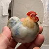 A plump, round rooster hand-carved from natural Shoushan stone, showcasing the natural colors and textures of the stone