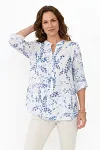 Front view of women's white and blue floral print linen shirt with roll-up sleeves and button front