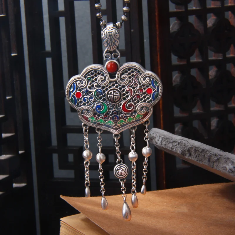 Pure silver dragon and phoenix symbolizing prosperity and longevity lock pendant