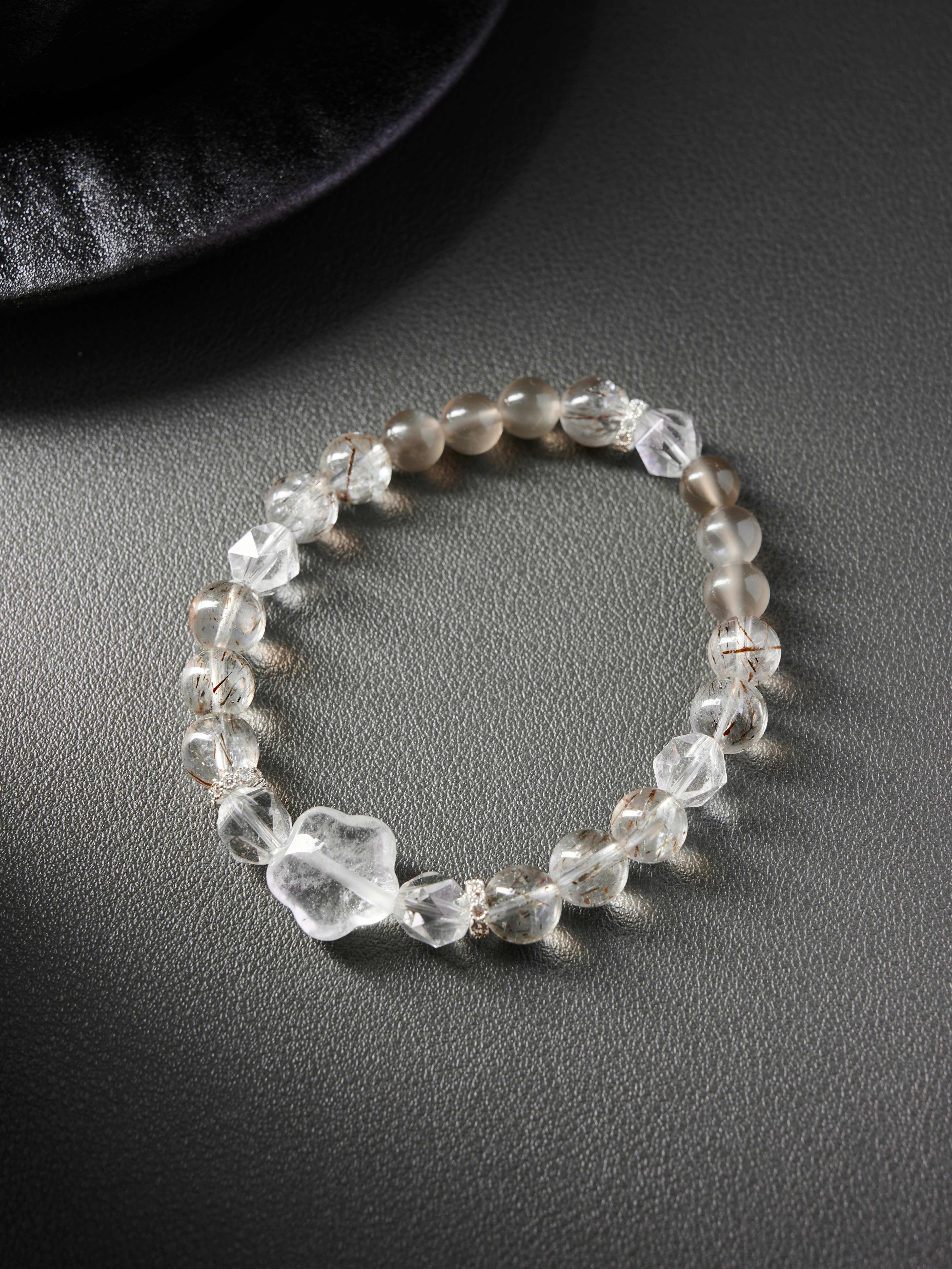 Flat lay circle on white background showing golden rutile beads with clear and rose quartz accents