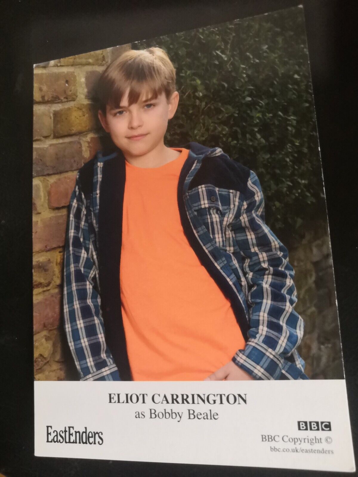 EASTENDERS UNSIGNED CAST CARD OF ELIOT CARRINGTON