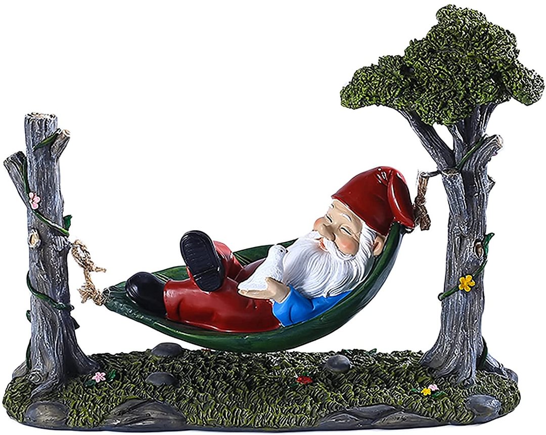 Garden Gnome Statue Lying In Hammock Hanging From Tree