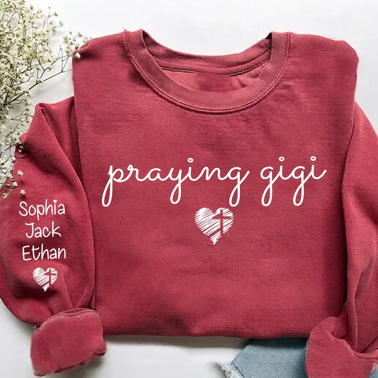 Personalized Praying Gigi Sweatshirt, Custom Grandkids Names Sleeve, Christian Grandma Shirt, Faith Cross Heart Gigi Sweatshirt
