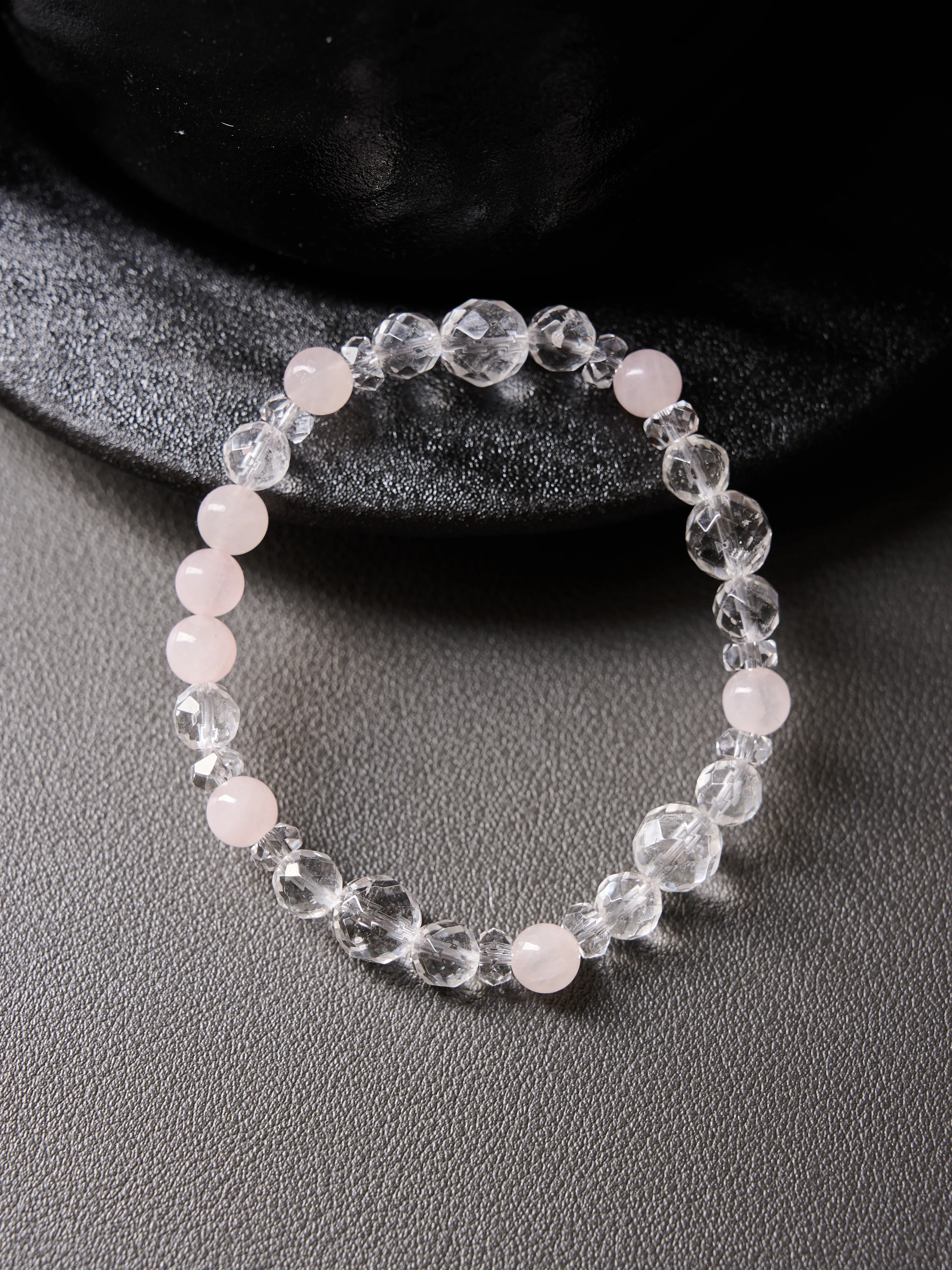Minimal flat composition with alternating rose quartz and faceted clear quartz, hand-strung