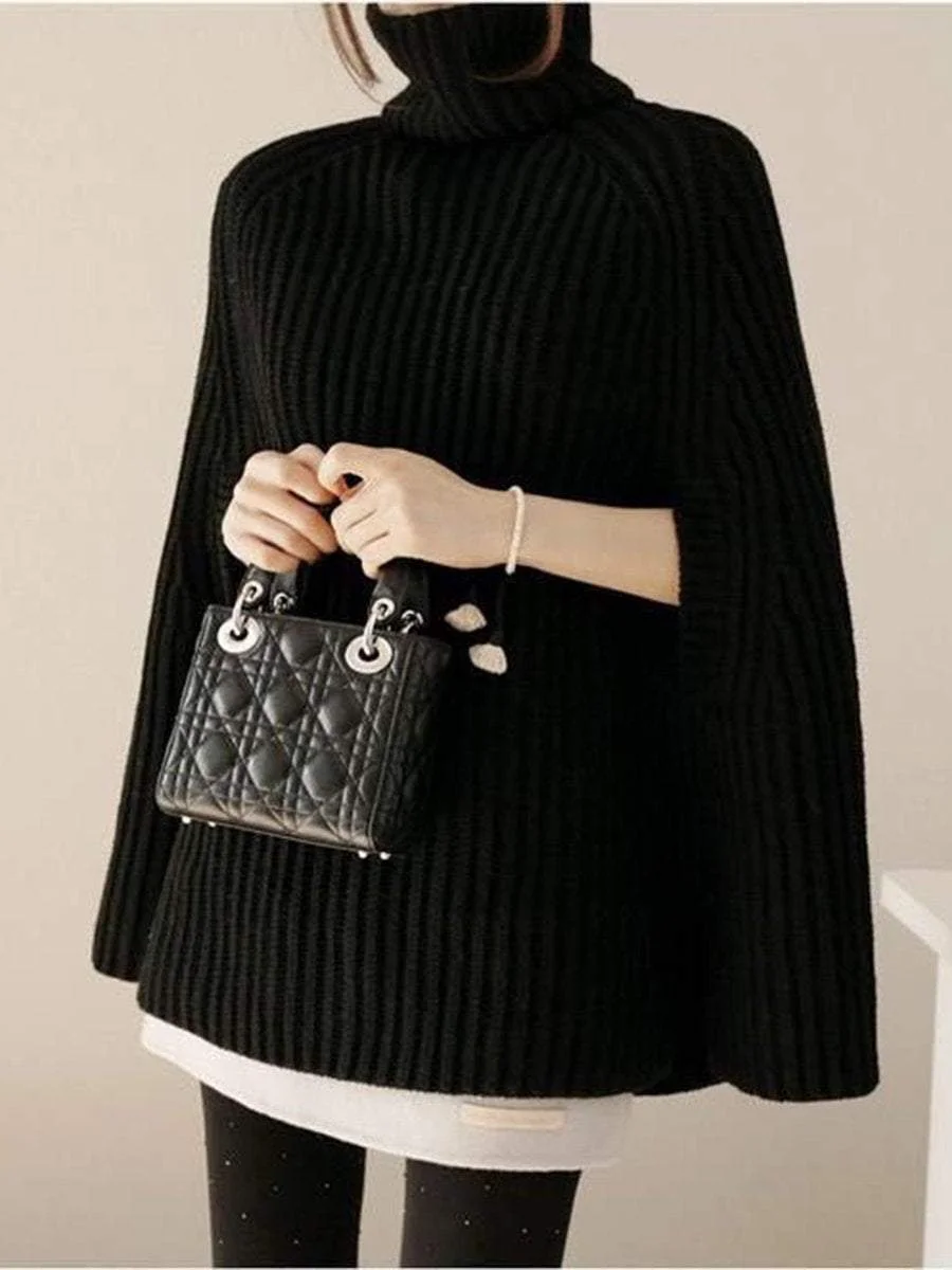 A pullover with a high collar that goes with a poncho knit sweater with split ends
