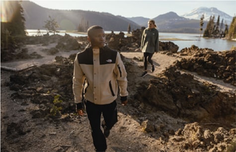 man walking in the mountains wearing fleece