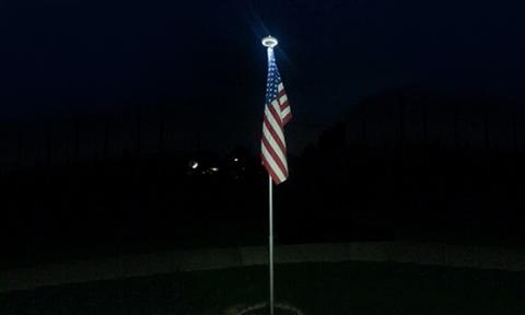 solar flagpole light working in the night