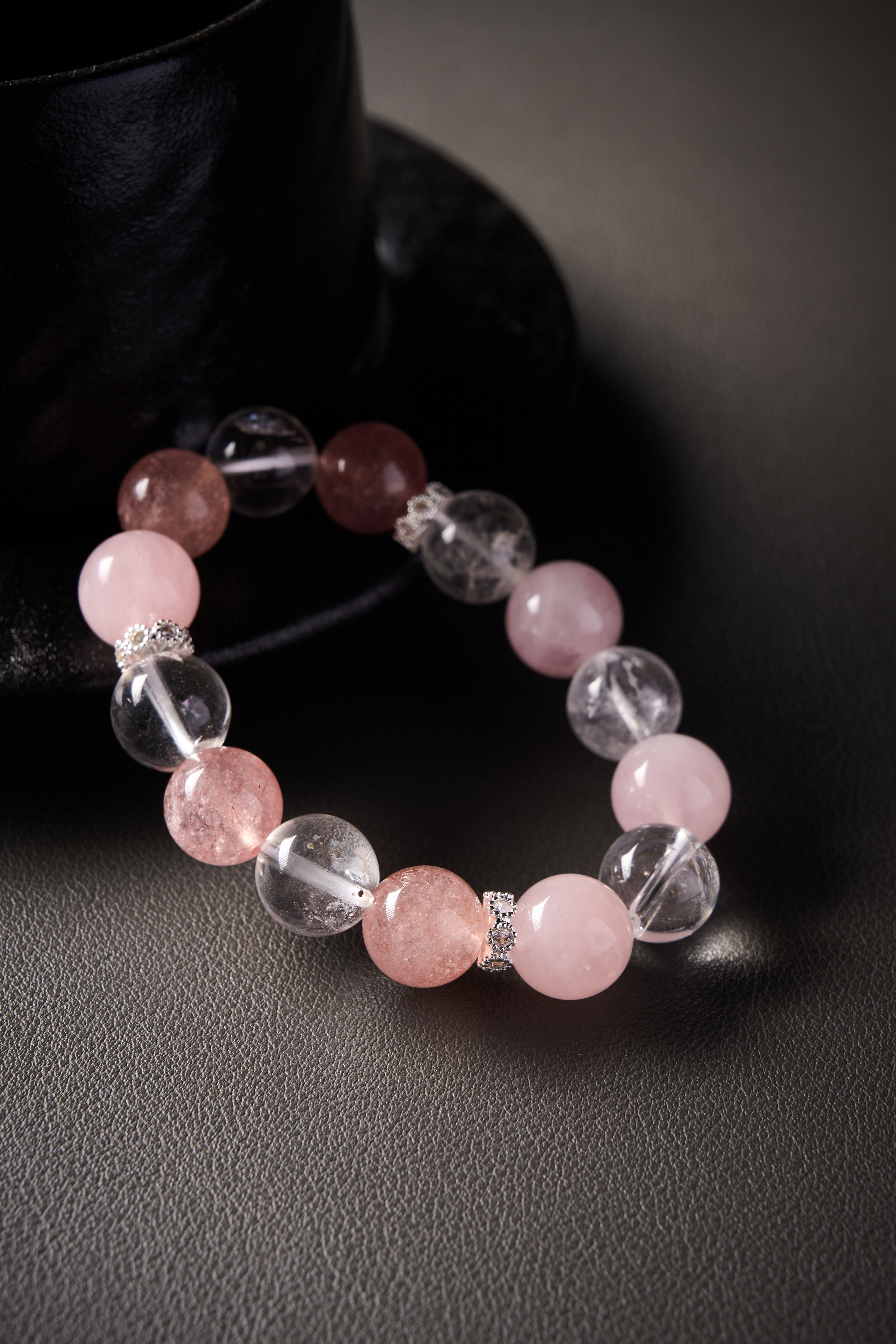 Detail – strawberry quartz bead showing fine inclusions, paired with metal spacer.