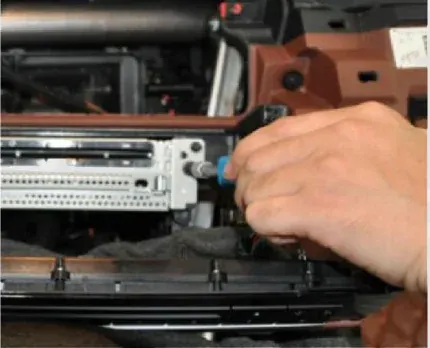Side retaining screw being removed from the BMW F10 CD head unit