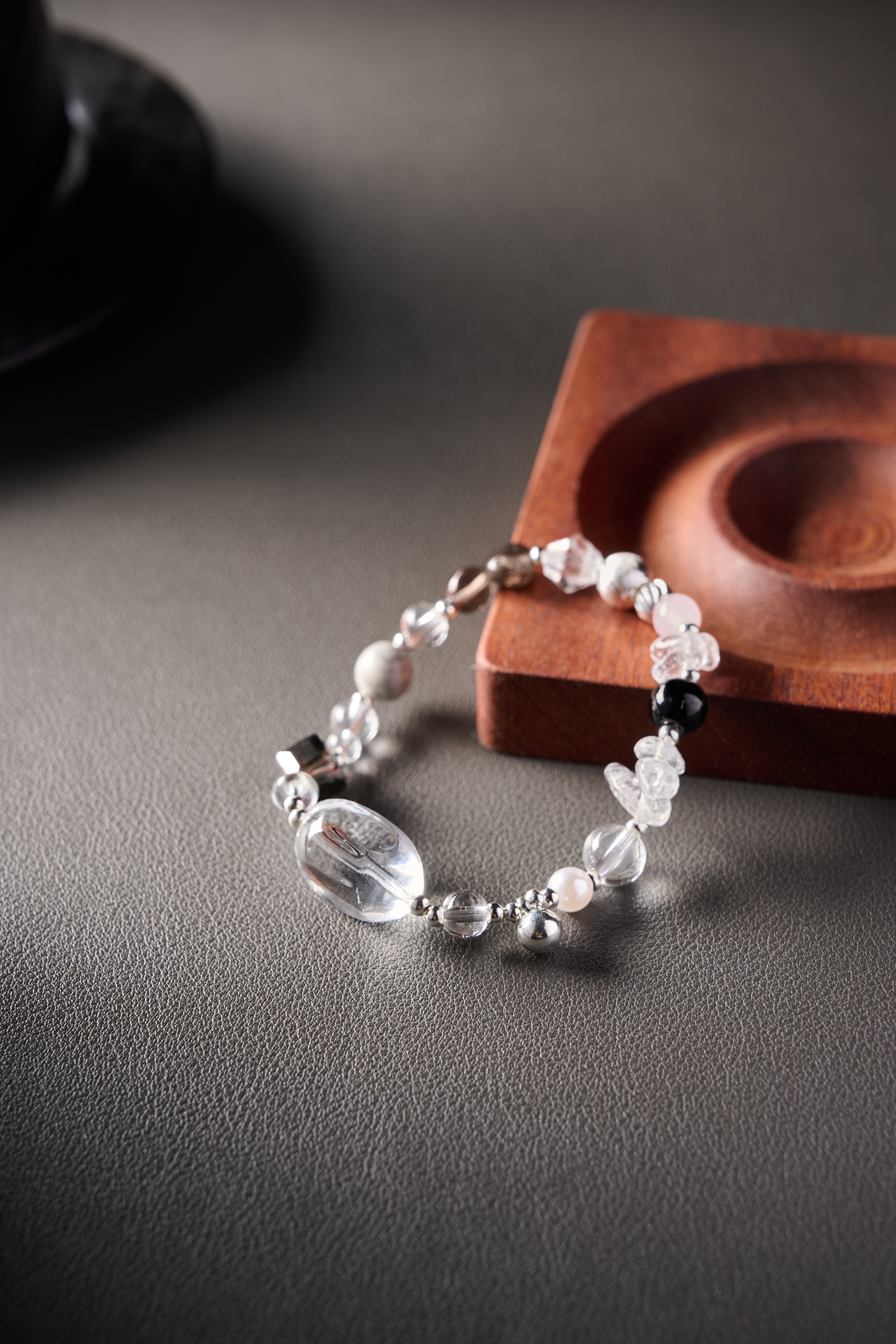 Lifestyle display – elegant minimal jewelry styling with soft lighting.