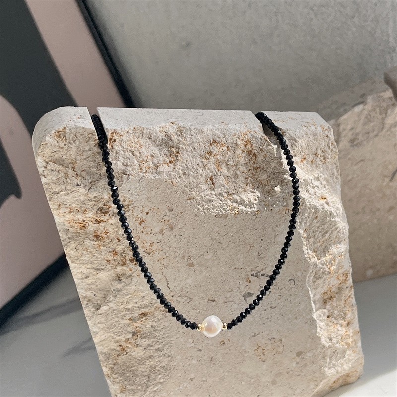 Elegant pearl clavicle chain styled with a white blouse