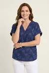 Front view of women's navy blue floral jacquard V-neck top with textured fil-coupe pattern and short sleeves