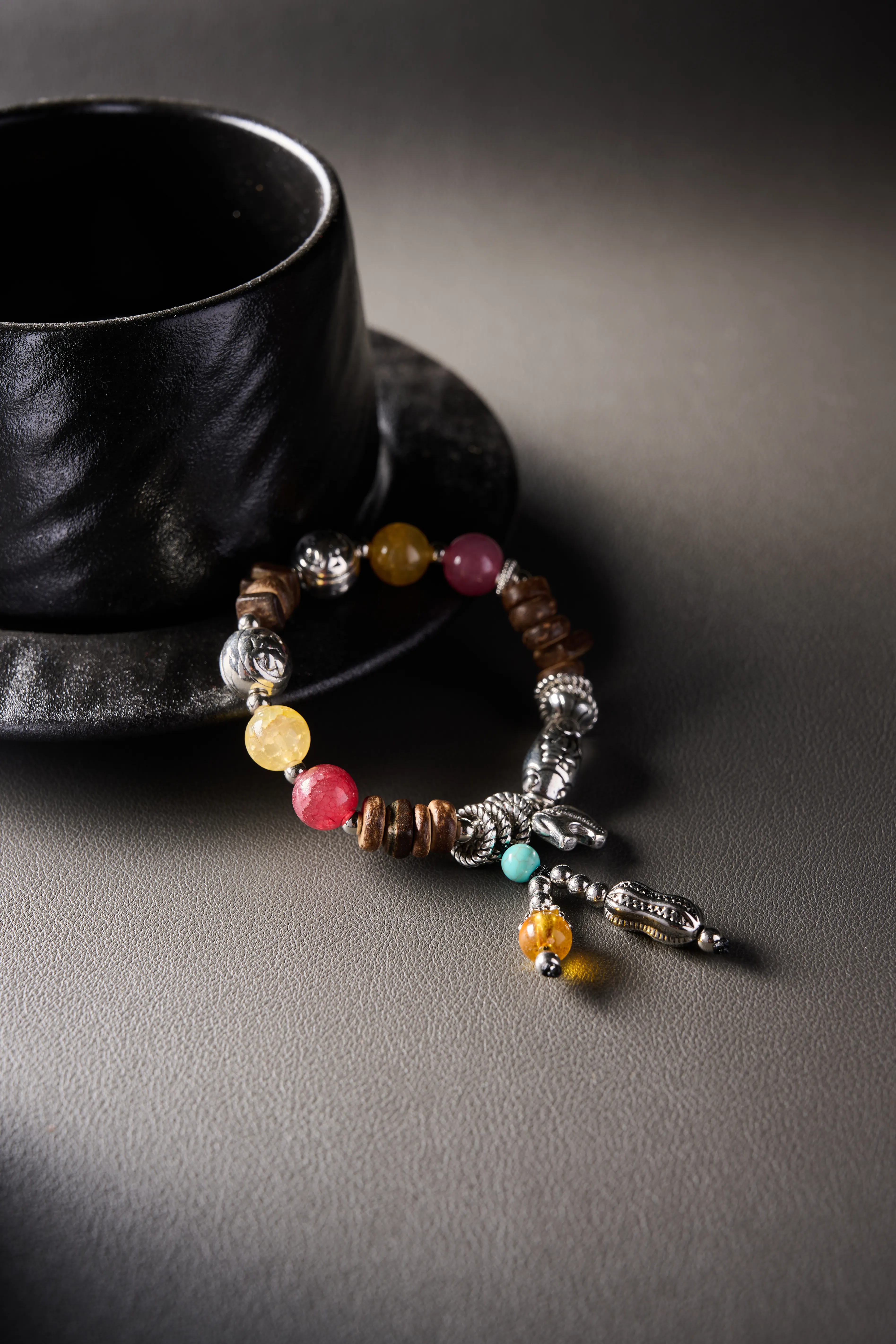 Charm focus – gourd/tassel dangle with amber-tone bead, delicate metalwork.