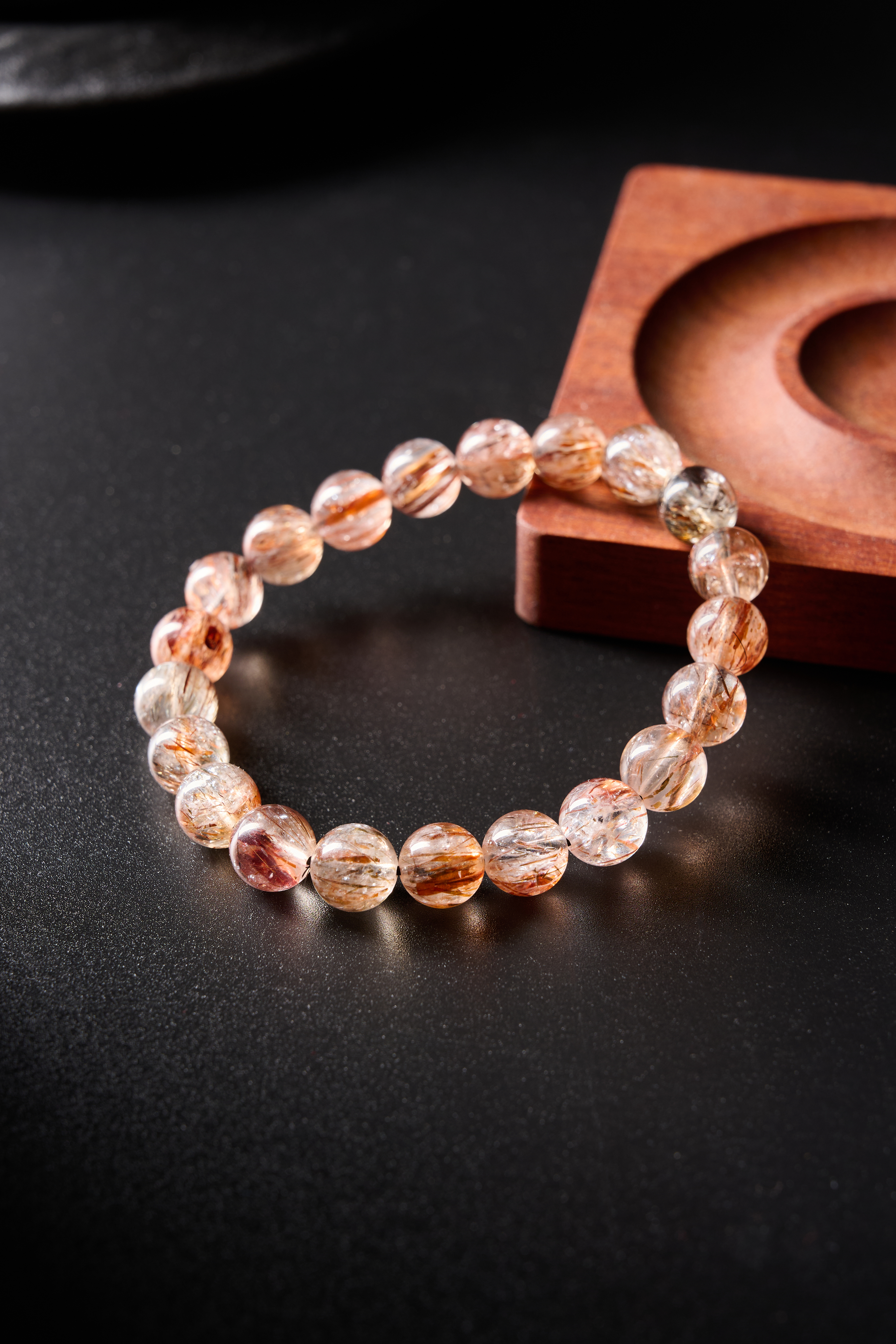 Flat arrangement showing even spacing and natural color variation across rutilated quartz