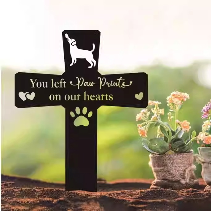 Metal pet memorial garden stake with engraved dog name in flower garden