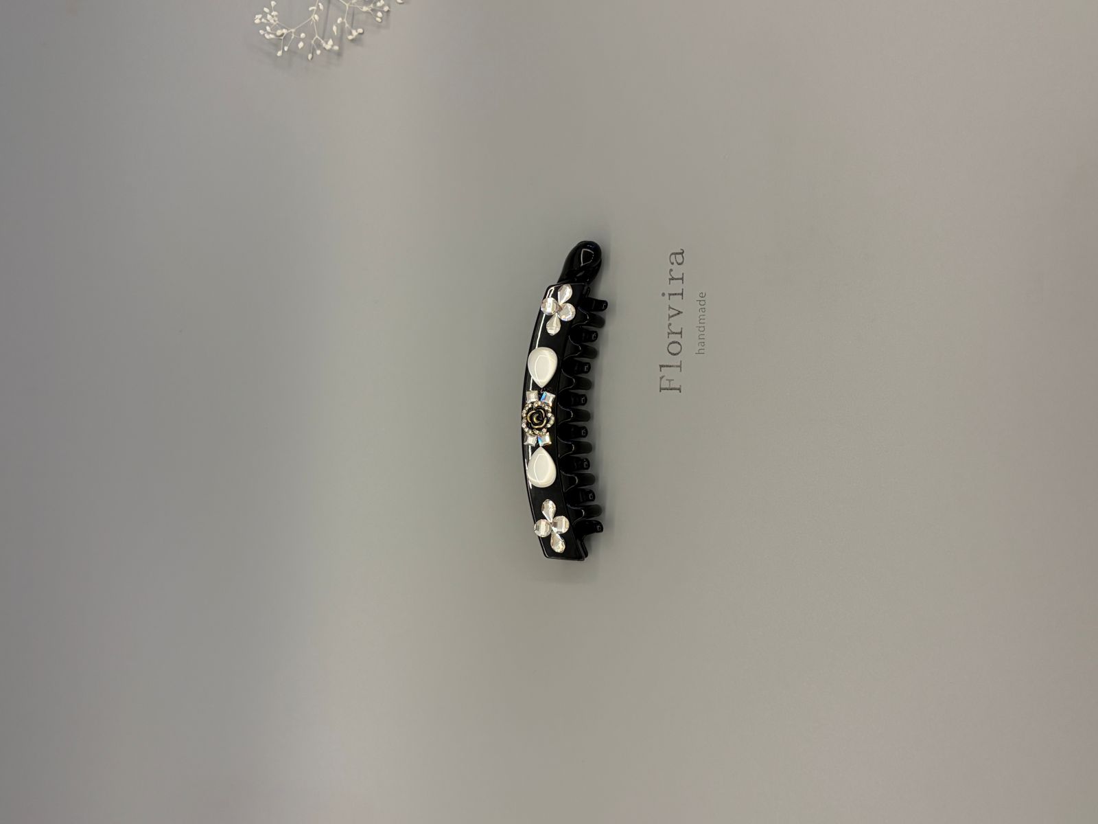 Black PC smooth edge banana hair clip with multi-faceted glass rhinestones, white resin cat's eye teardrop and rose flower decor