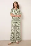 Front view of women's grass green zebra print two-piece set with short sleeve shirt and wide-leg pants