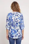 Back view of blue floral print blouse for mature women with roll-tab sleeves
