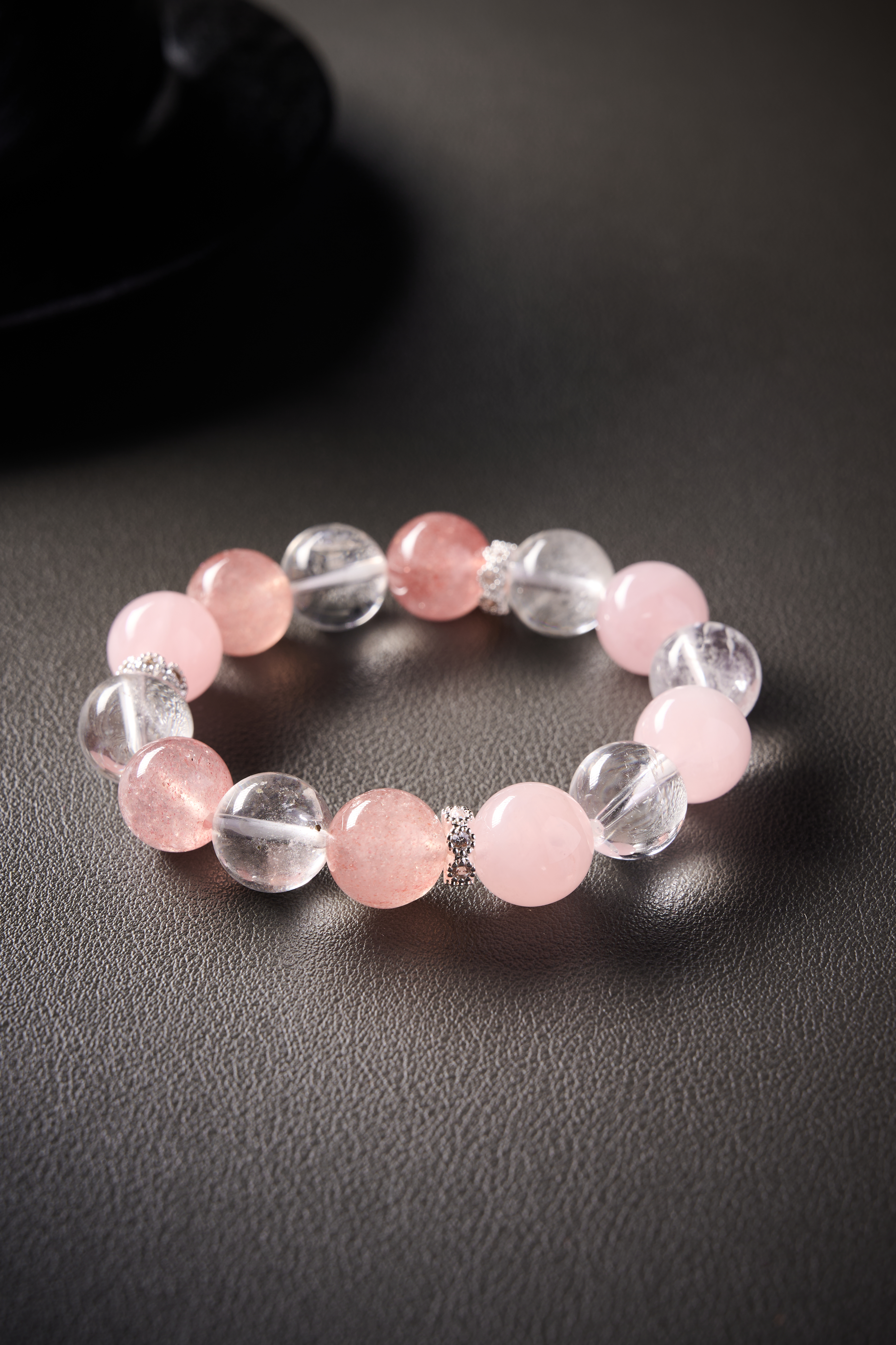 Close-up – soft pink rose quartz next to transparent clear quartz, smooth surface and natural shine.