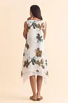 Back view of women's sleeveless leaf print midi dress with asymmetric handkerchief hem