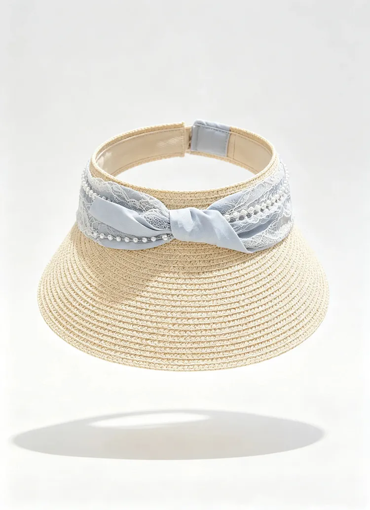 Open-top sun hat with lace paneling and a pearl-accented bow.