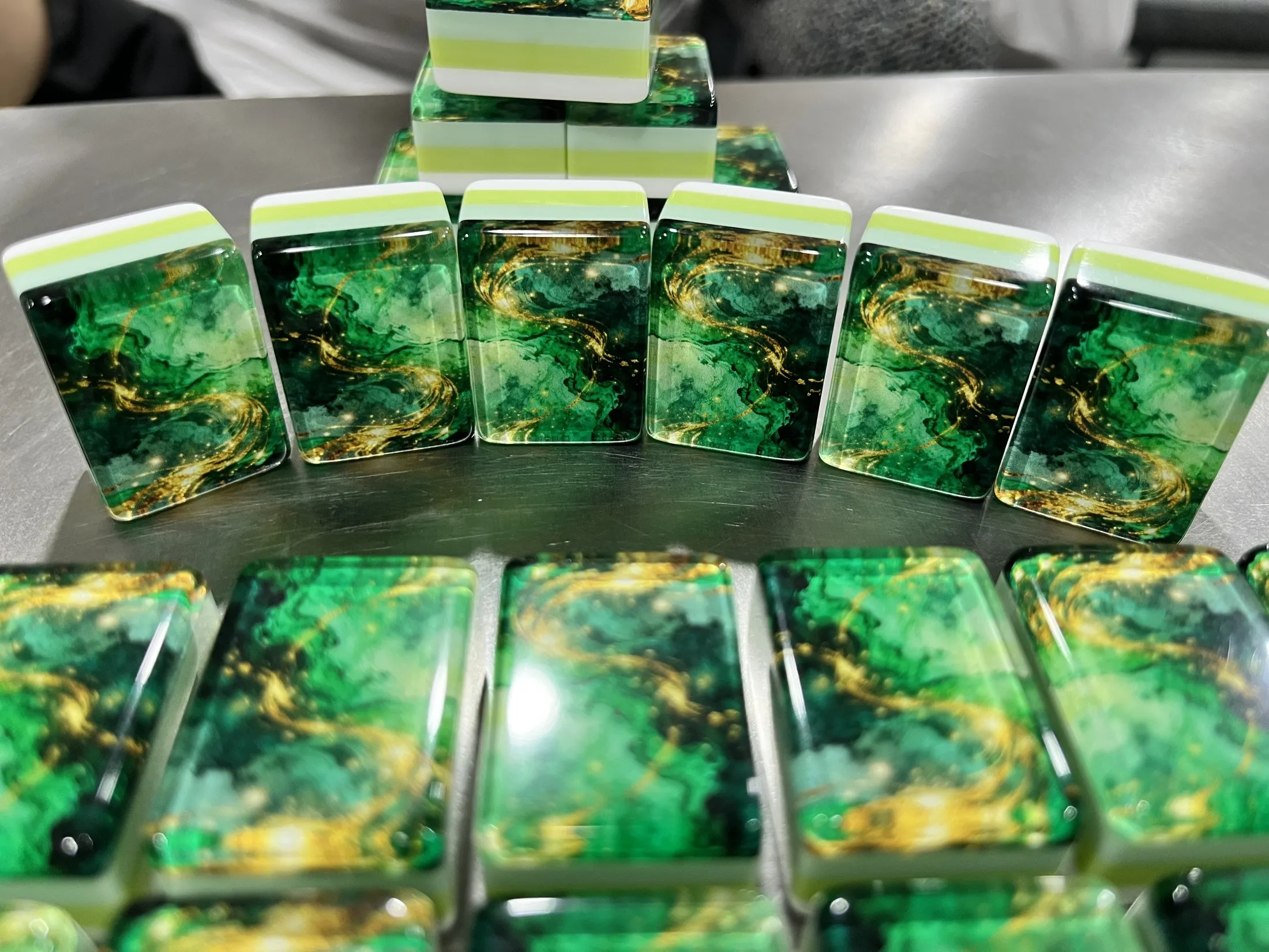 A polished emerald-gold back shown in hand for close detail.