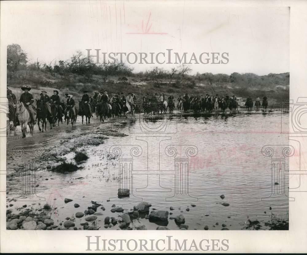 Press Photo Poster painting Trail Riders Cross Stream on Horseback - sax29320