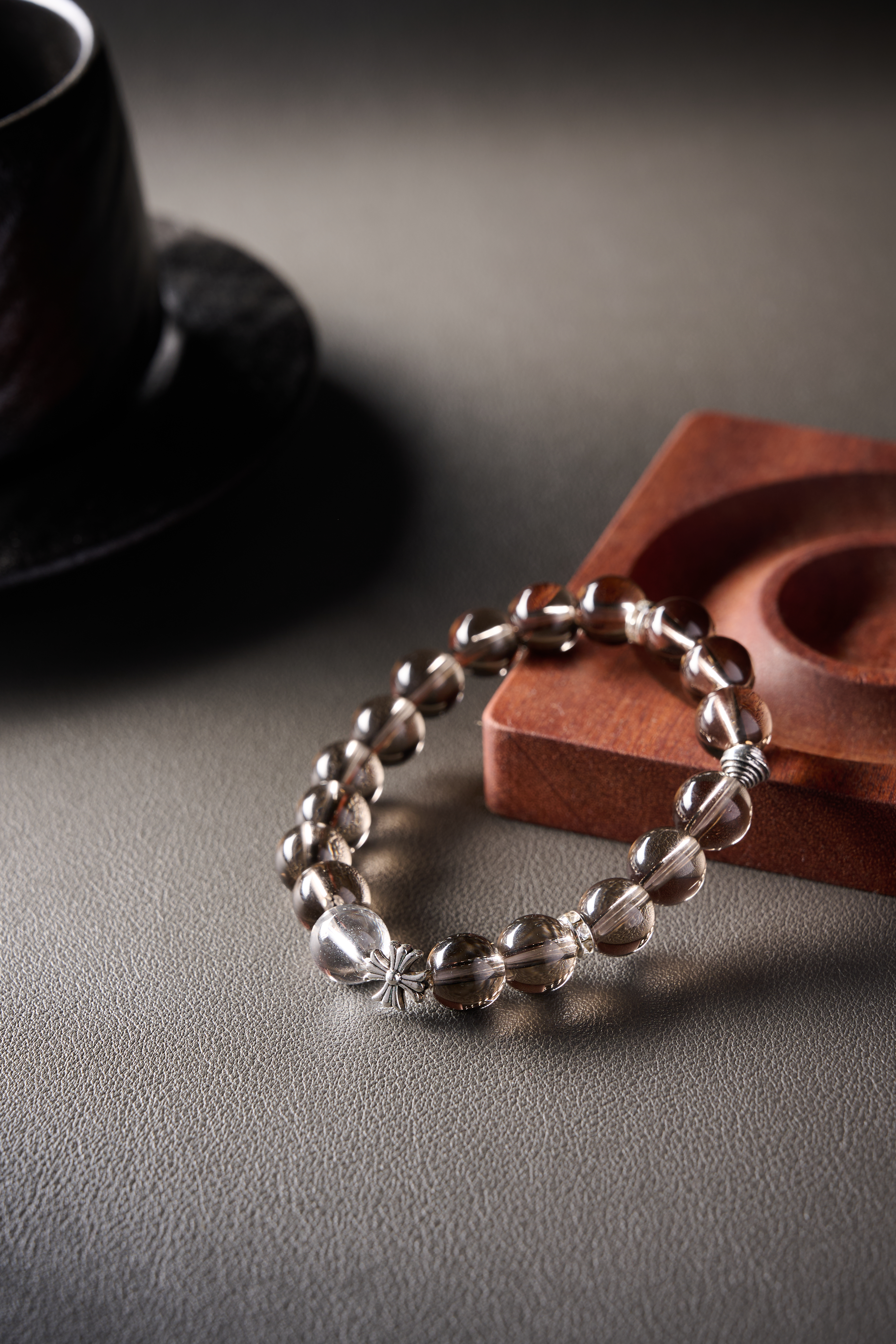 Texture highlight – smooth bead surface under soft light, deep smoky hue for grounding style.