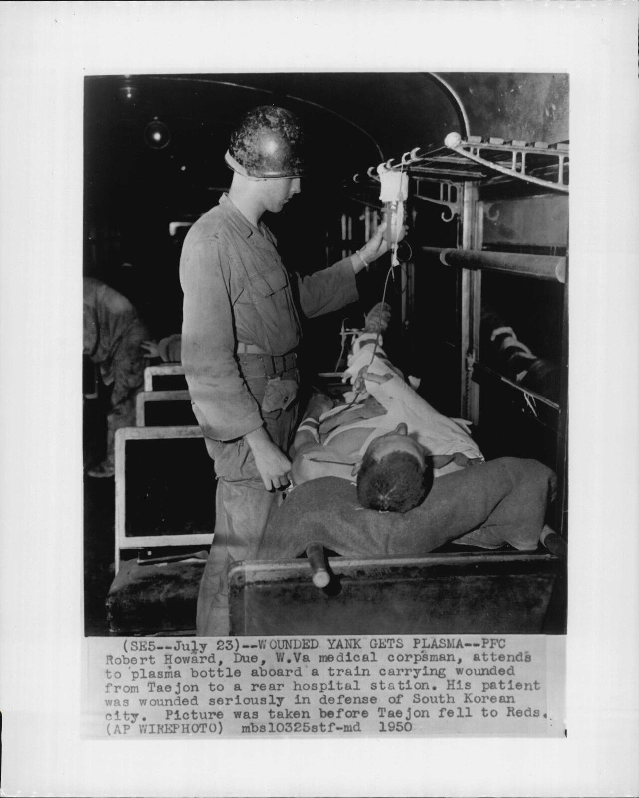 Robert Howard Checks Plasma Bottle on Train 1950 Korea War Press Photo Poster painting