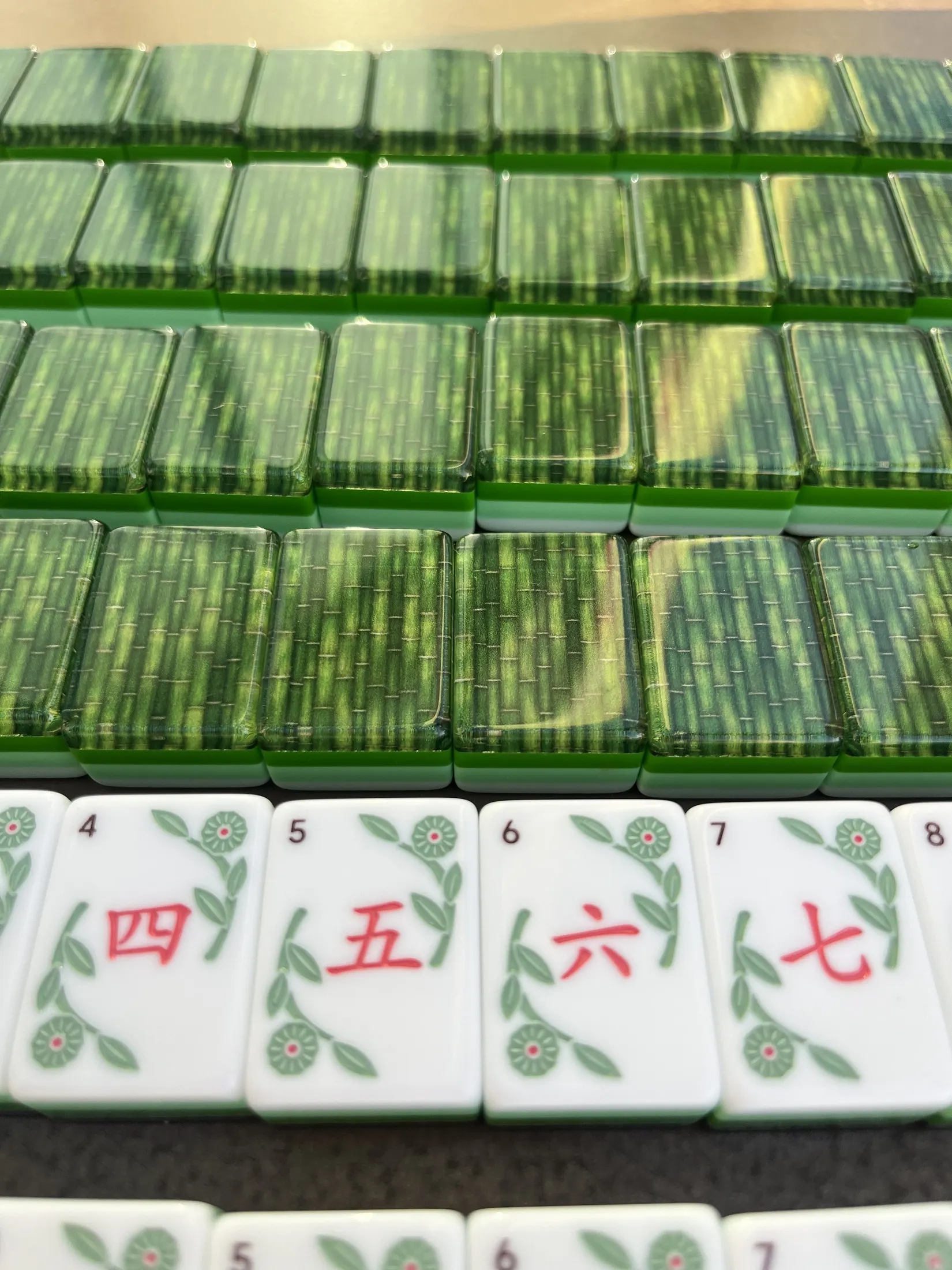 A close-up of the bamboo grain and engraved number tiles.