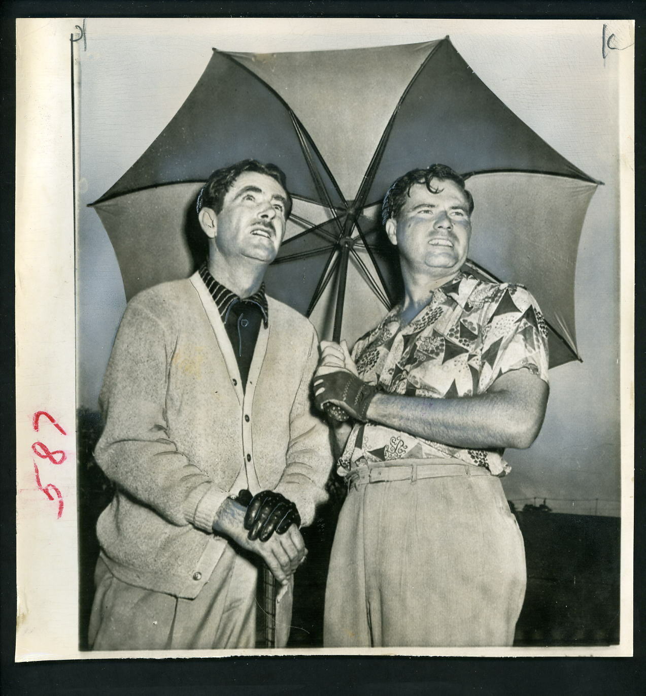 Lloyd Mangrum & Chic Harbert under umbrella at 1950 Masters Press Photo Poster painting