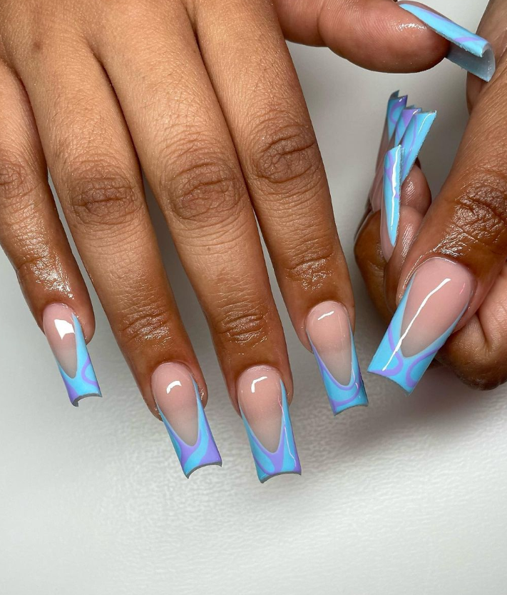 Female Hand With Vacation Nail Design. Glitter Blue Nail Polish Manicure  With Colorful Abstract Nail Art. Female Model Hand With Perfect Blue  Manicure With Beautiful Waterfall On Background. Copy Space. Place For