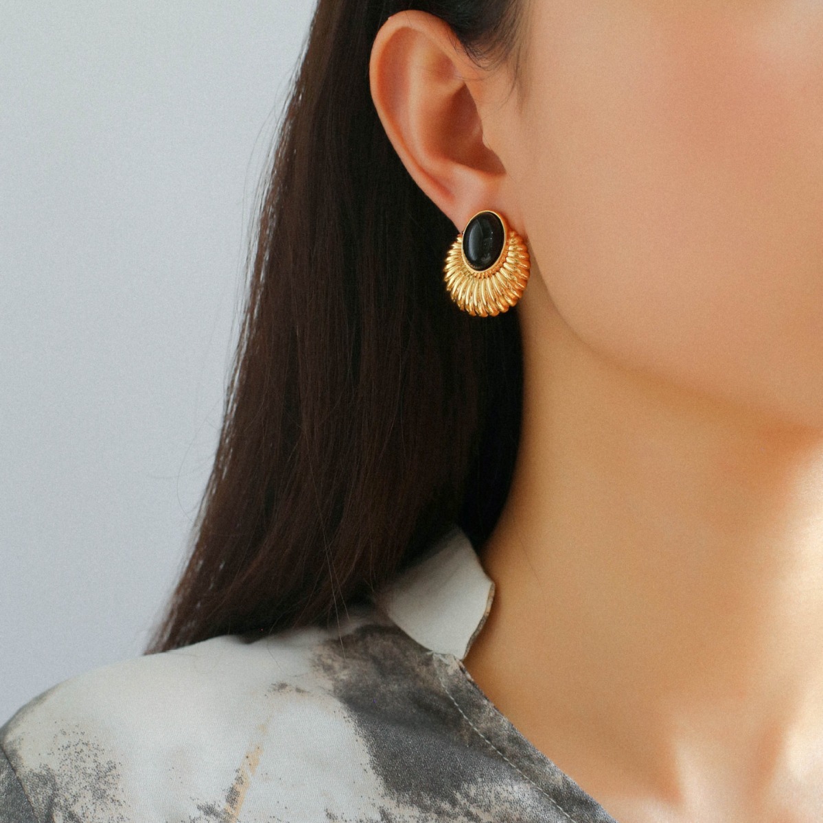 "Close-up of vintage black onyx stud earrings with a timeless retro design"