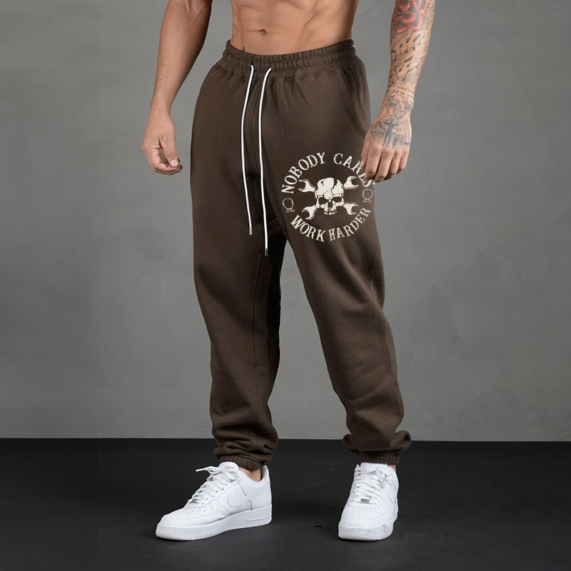 NOBODY CARES, WORK HARDER SKULLS WITH HANDLES PRINT JOGGERS