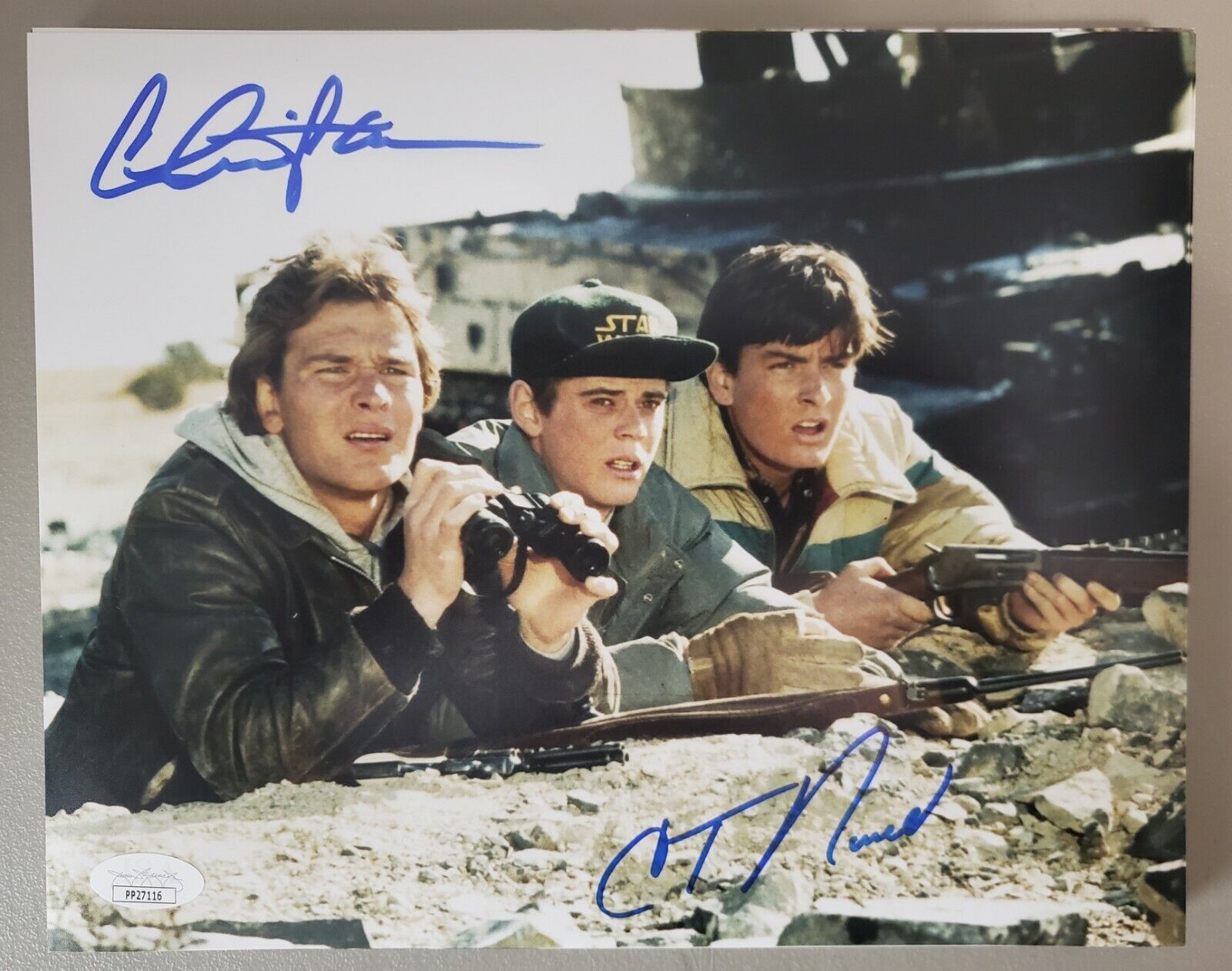 8X10 Autographed by Charlie Sheen and C Thomas Howell in Red Dawn. JSA