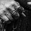 Bearded tough guy wearing hat skull rings for men
