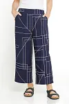 Front view of women's navy blue wide-leg pants with white geometric linear print and side pockets