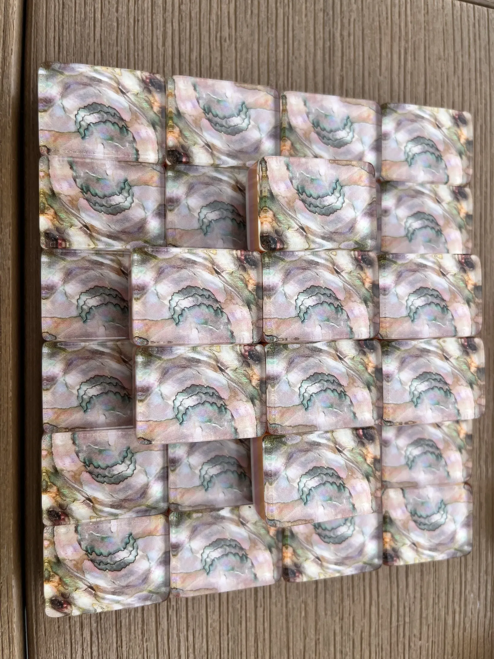 A real patterned tile held in hand for scale and finish detail.