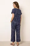 Back view of women's geometric co-ord set showing short sleeves and button-back detail