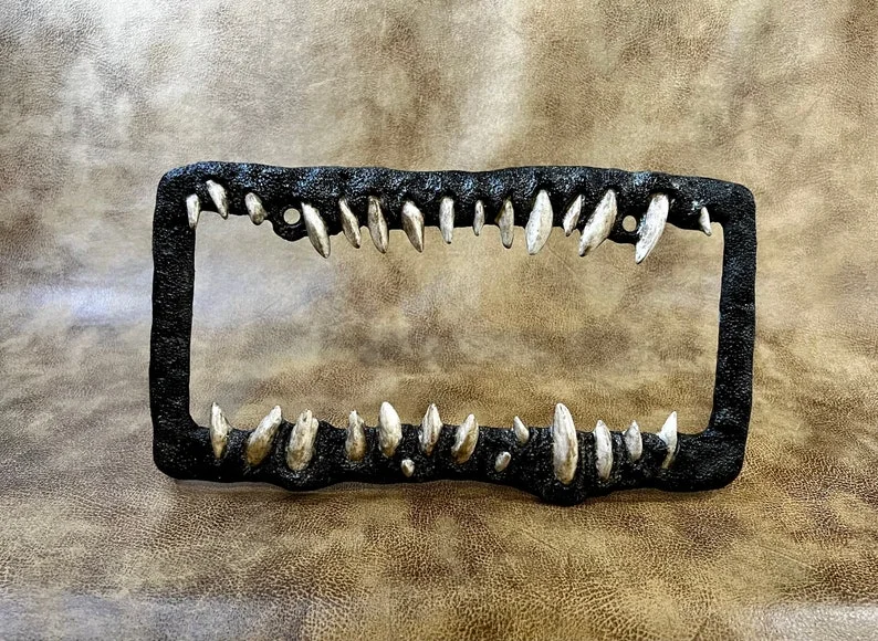 Creature teeth license plate frame